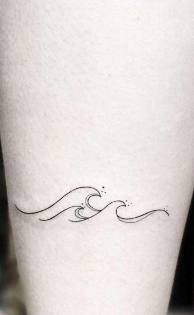 a small wave tattoo on the leg