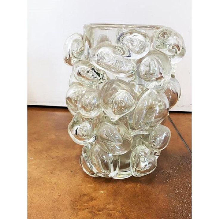 a glass vase filled with lots of clear balls