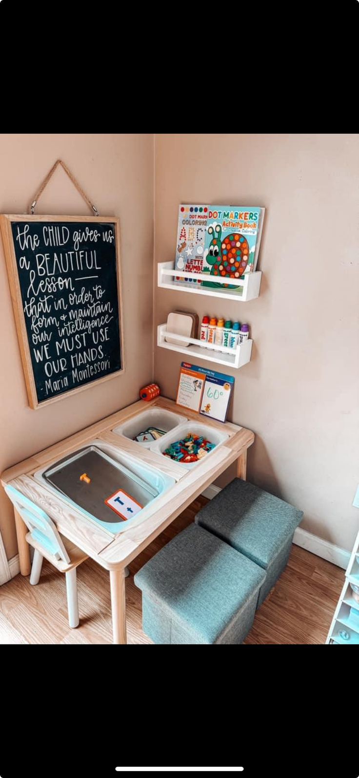 a child's playroom with a chalkboard on the wall next to it