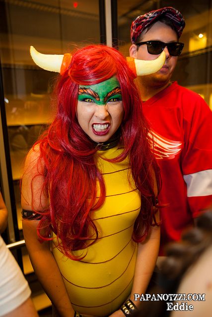 two people dressed up in costumes and one has horns on his head, while the other is