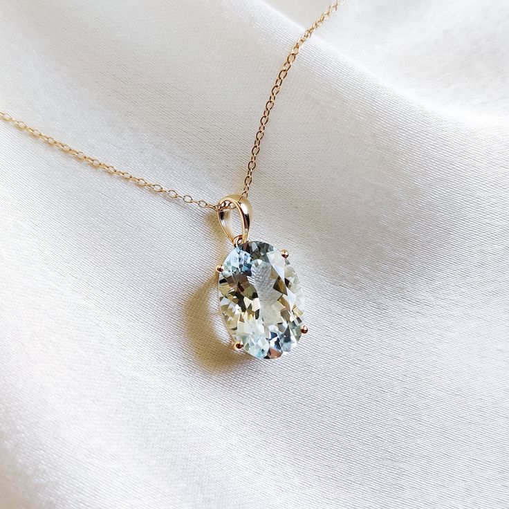 This stunning pendant is set in 14k Solid Yellow Gold with Natural Aquamarine with utmost precision. It is an unique gemstone Pendant for nearly every occasion and is completely hassle-free jewelry. ITEM DETAILS: * Gem: Aquamarine * Gem Size: 10X14mm * Gem Shape: Oval Cut * Gem Weight:5.18 carats * Gold Purity: 14KT * Gold Weight: 1.11 gram * Total Weight of the Pendant: 2.15 gram The Gold purity is guaranteed and it comes with authentic 14KT gold hallmark. Since my items are handmade, they are absolutely nickel and lead free. CUSTOMIZATION: * Gemstone customization is available and it can be substituted with a gem of your choice. Kindly message me for the same. PACKAGING * The Pendant comes with layers of safe and secure wrapping along with Free handmade jewelry box with every purchase. ➡