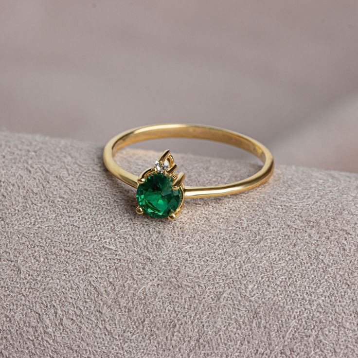 Emerald is known as the stone of love and loyalty. Emerald contributes to the development of emotional bonds. Emerald is the birthstone for those born in May. Meet the essence of elegance: Solitaire emerald ring. Handcrafted with precision, this exquisite piece features a majestic sapphire set in a magnificent design. A symbol of timeless beauty, it embodies sophistication and elegance. Elevate your style with this breathtaking masterpiece. A stylish jewel for you and your loved ones. Time to pa Gold Plated Birthstone Rings As Gift, Gold Plated Green Rings For Gift, Green Gold Plated Rings For Gift, Elegant Gold Emerald Ring With Round Band, Gold-plated Birthstone Ring, Gold Solitaire Birthstone Ring For May, Gold Emerald Solitaire Birthstone Ring, Gold Emerald Birthstone Promise Ring, Gold May Birthstone Ring As Gift