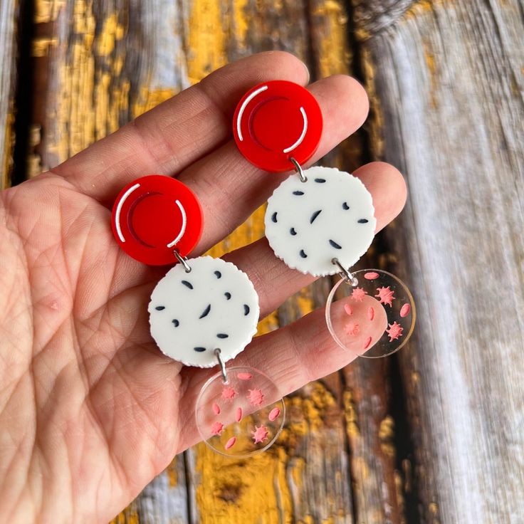 Haematologists rejoice! If you love blood, these are probably the earrings for you! Red Blood Cells (erythrocytes), White Blood Cells (leukocytes,) and Platelets (thrombocytes) are laser cut from acrylic, hand-painted and strung together into a pair of dangly earrings.  The earrings measure 6cm from top to bottom.  The earrings have stainless steel earring posts paired with comfort clutch ear nuts. Oh Pluto Jewellery is: Hypoallergenic and tarnish resistant: All metal findings are 304 or 316 Sta White Blood Cell, White Blood, White Blood Cells, Red Blood, Red Blood Cells, Blood Cells, Earring Posts, Earrings Red, Dangly Earrings