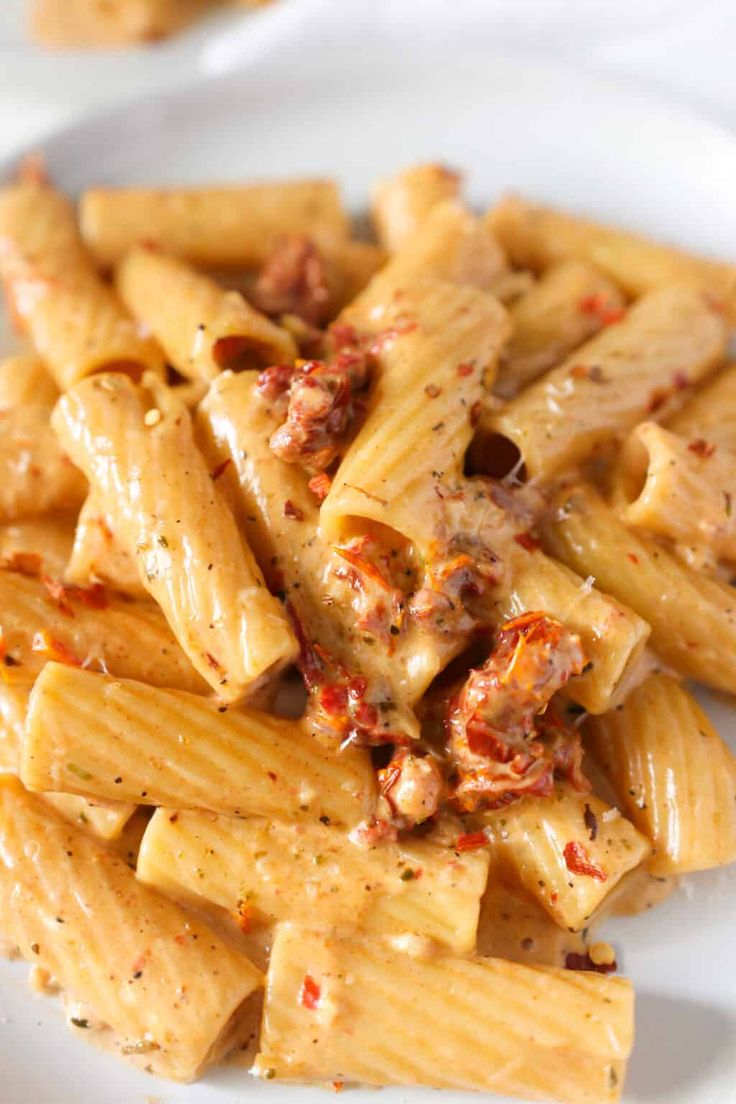 pasta with meat and sauce on a white plate