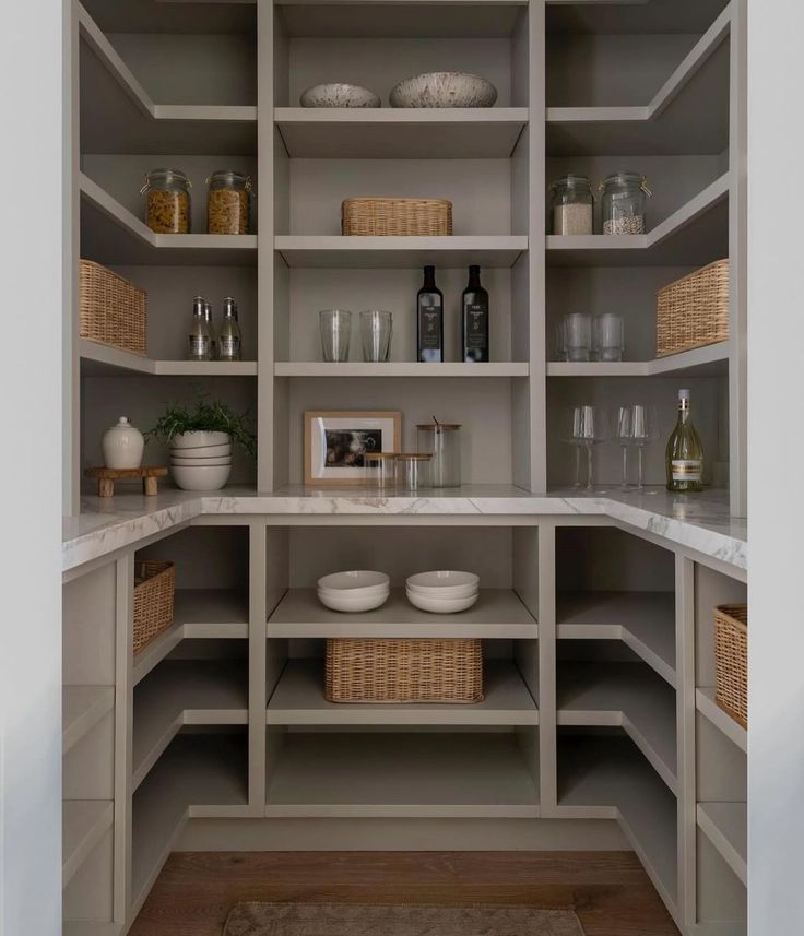 an empty pantry with lots of shelves and bowls