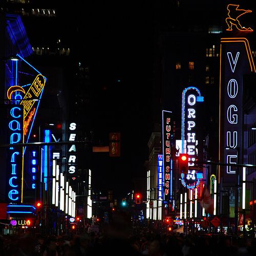 a city street filled with lots of neon signs