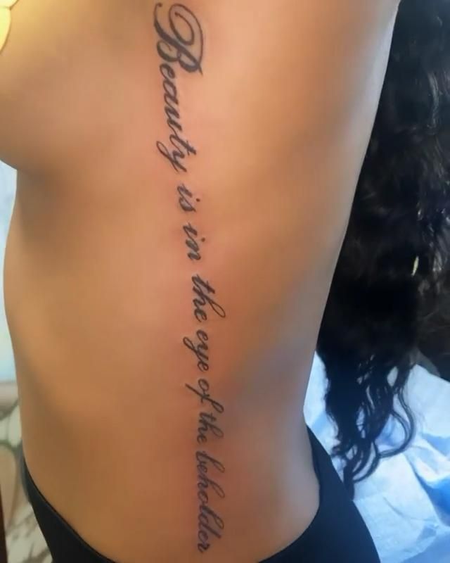 the back of a woman's stomach with words written in cursive writing