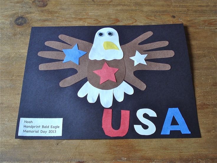 an eagle made out of paper on top of a wooden table with the words usa