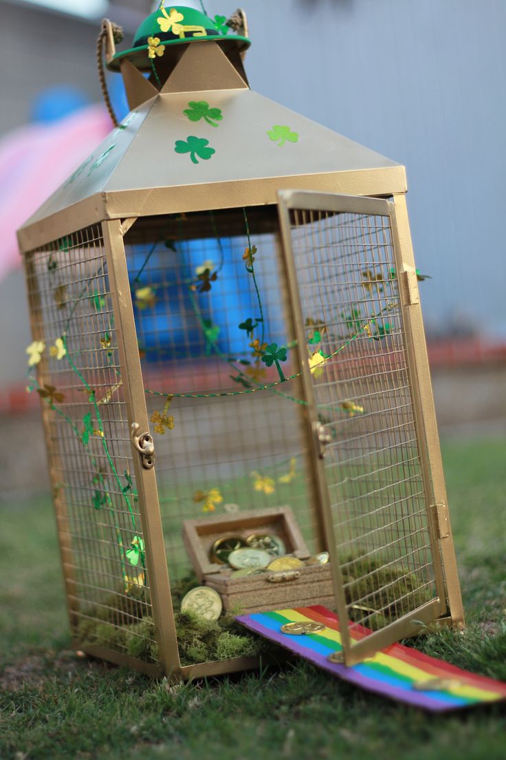 a small birdcage sitting on top of a grass covered field