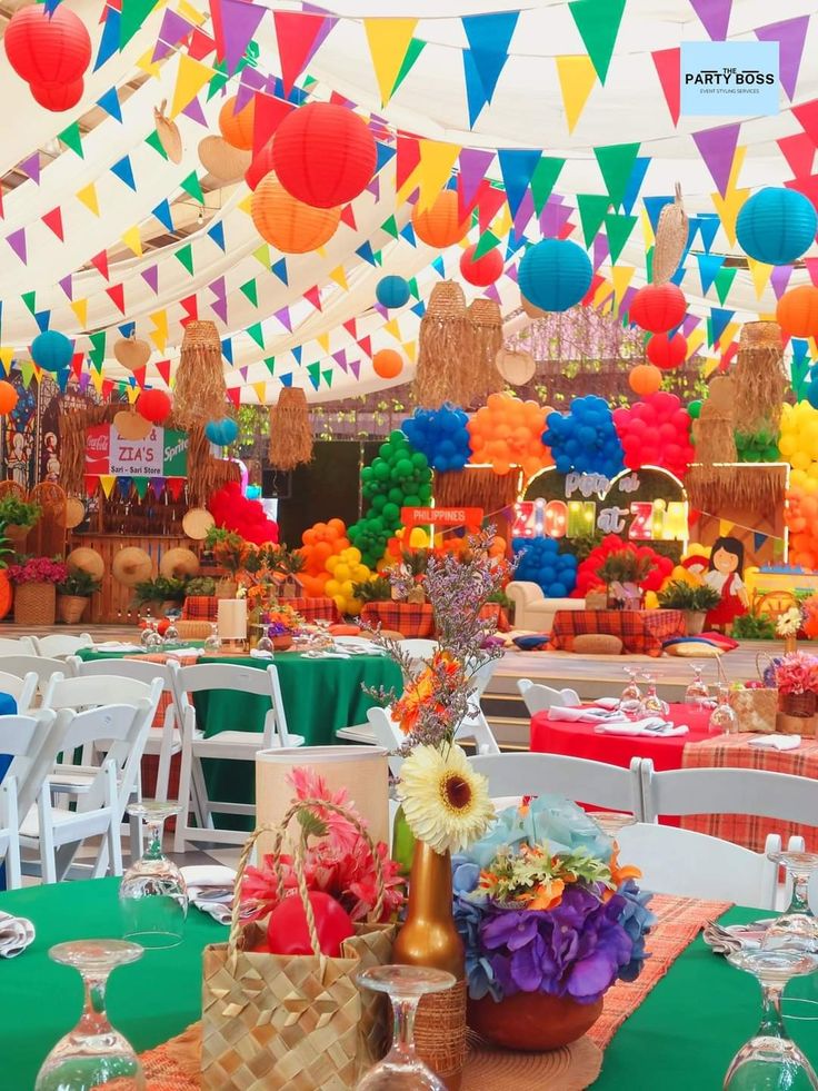 an outdoor party with colorful decorations and tables