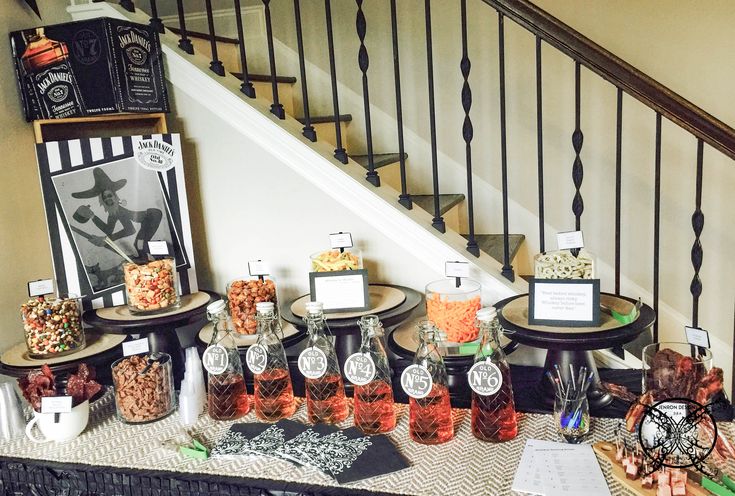 the table is set up with candy and candies for guests to eat in front of the staircase