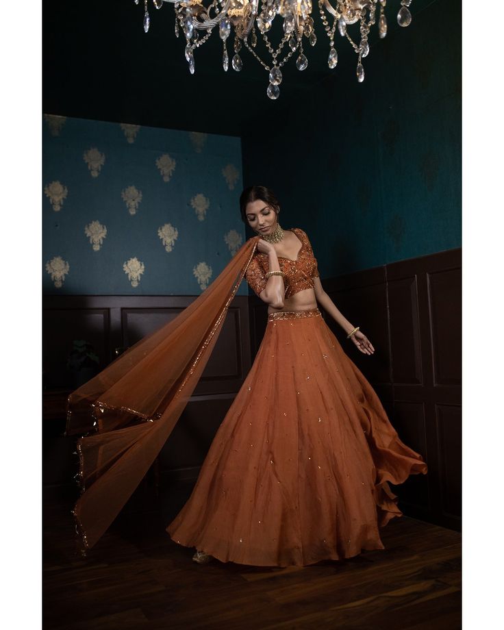 Orange Georgette Sets For Reception, Orange Organza Wedding Dress, Brown Wedding Lehenga With Traditional Drape, Brown Lehenga For Wedding And Festivals, Brown Wedding Lehenga For Festivals, Elegant Orange Choli For Festive Occasions, Elegant Orange Choli For Festive Season, Elegant Orange Festive Choli, Elegant Orange Sets For Navratri