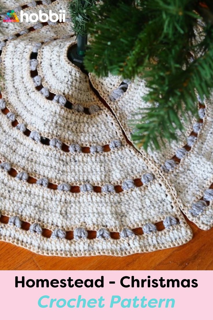 a crocheted christmas tree skirt is on the floor next to a fir tree