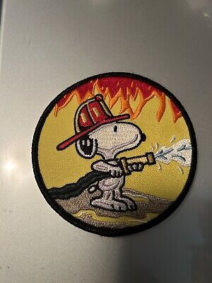 a sticker on the side of a refrigerator with a fireman holding a hose