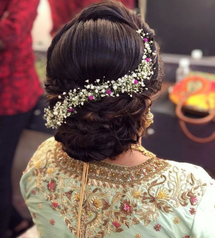 a woman wearing a hair comb with flowers in her hair