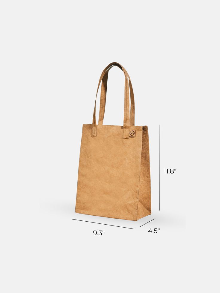 The mini version of our beloved Market Tote helps you keep your essentials in check while adding a simple, minimalistic flair to any daily adventure. With all the same functionalities as the Market Tote, this compact and convenient tote is perfect for lunches or lighter days. Modern Recyclable Bags For Everyday Use, Modern Everyday Recyclable Bags, Everyday Brown Recyclable Bag, Everyday Brown Recyclable Bags, Reusable Rectangular Bag For On-the-go, Functional Recyclable Lunch Bag For Travel, Casual Rectangular Lunch Bag For On-the-go, Brown Recyclable Bags For Daily Use, Versatile Recyclable Shoulder Bag For Daily Use