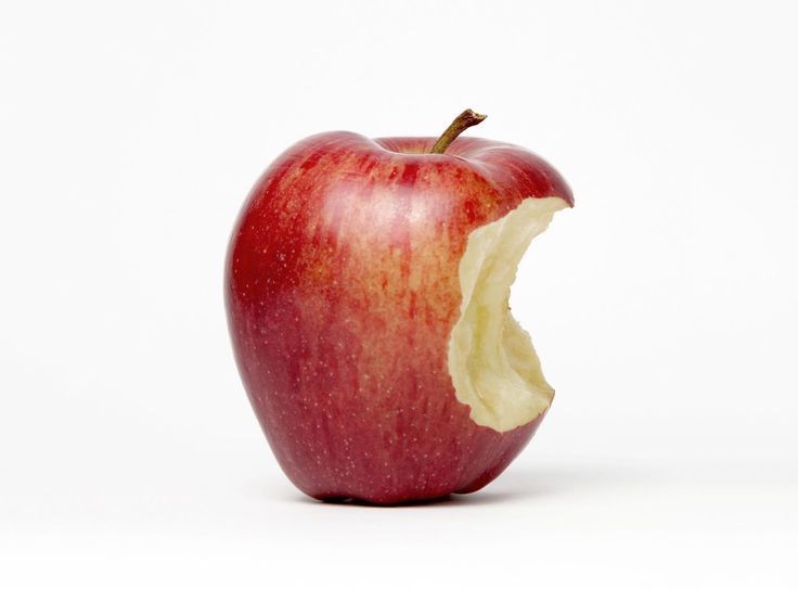 an apple that has been cut in half with the bite taken out and white background