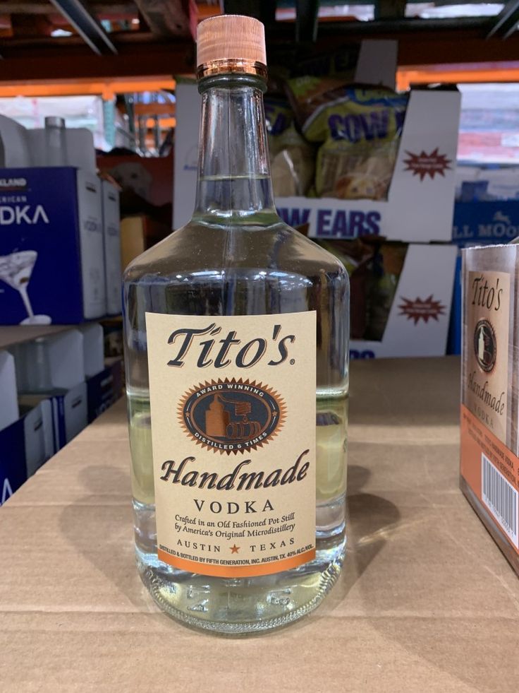 a bottle of tito's handmade vodka sitting on a table in a store