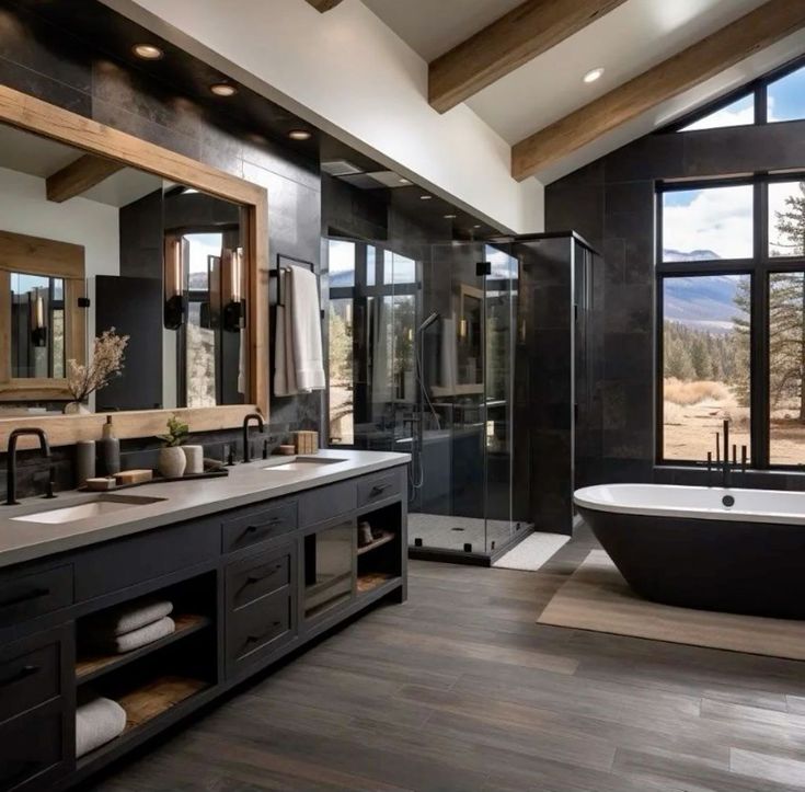 a large bathroom with two sinks and a bathtub next to a big window that looks out onto the mountains