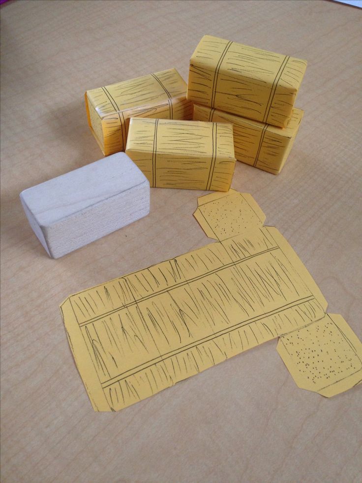 several pieces of yellow paper sitting on top of a wooden table