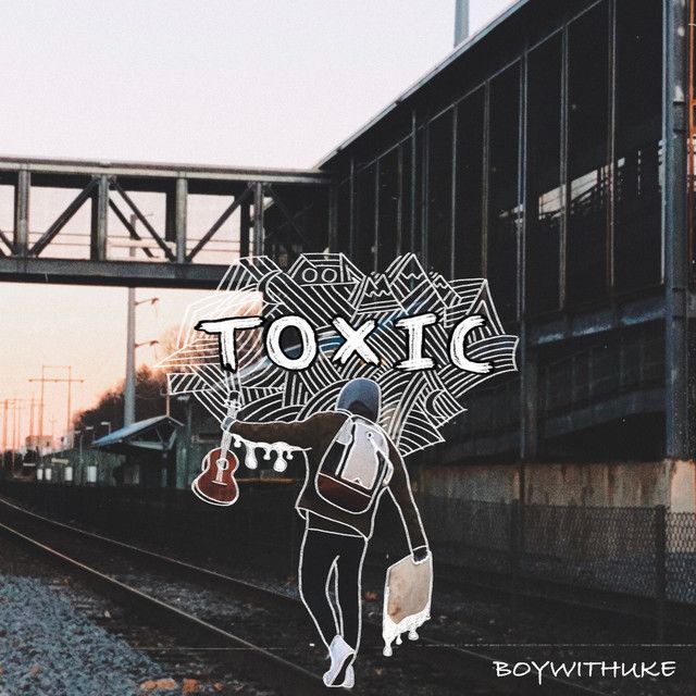 a person walking on train tracks with an umbrella over their head and the words toxic above them