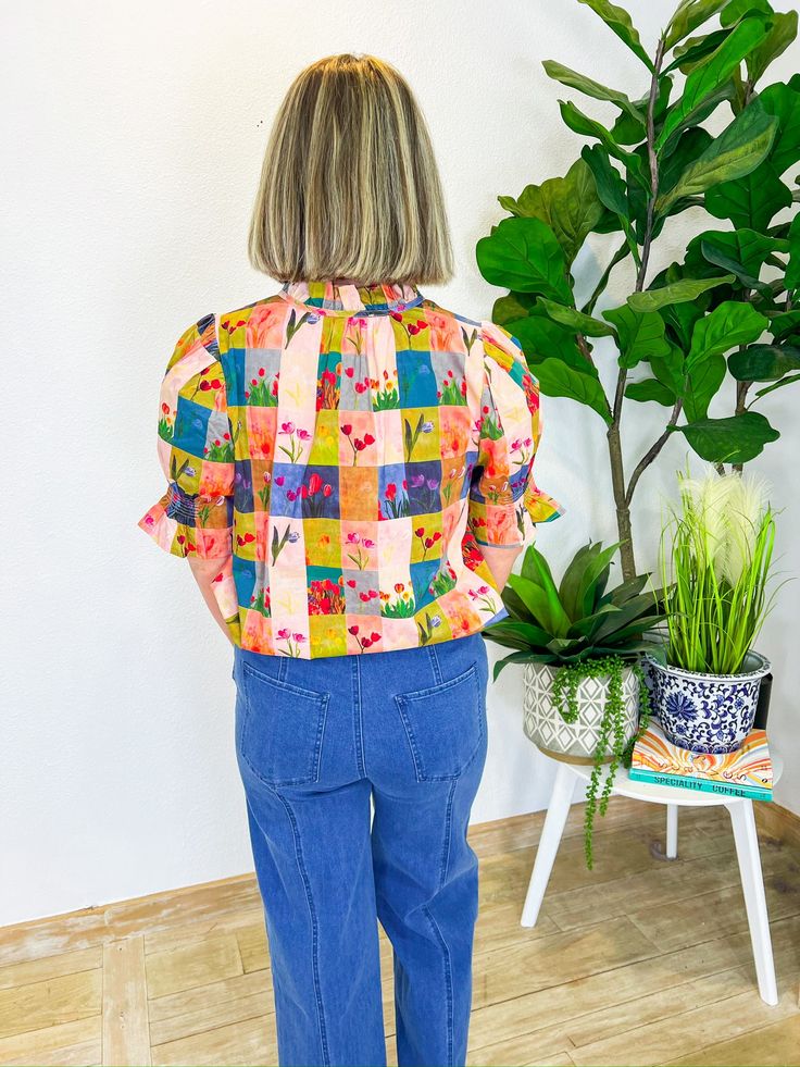 This cheerful gingham print, sprinkled with playful floral tulips, is just the thing to brighten up any day. Whether you're headed to a sunny picnic, a lively brunch with friends, or a casual day out, this top pairs perfectly with your favorite denim for a look that's effortlessly stylish. The button-down front adds a touch of vintage charm, making it a versatile piece that will keep your outfits fresh and fun all season long. PRODUCT FIT - TRUE TO SIZE MODEL DETAILS - BRENNA IS WEARING A SIZE S Spring Vacation Tops With Retro Print, Spring Casual Blouse With Retro Print, Casual Retro Print Blouse For Spring, Casual Spring Blouse With Retro Print, Vibrant Print Blouse For Brunch, Casual Blouse With Retro Print For Spring, Multicolor Blouse For Brunch In Spring, Retro Tops With Colorful Pattern For Spring, Pink Fruit Print Tops For Spring