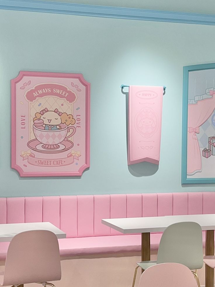 there are pink and blue walls in the restaurant with pictures on the wall behind them