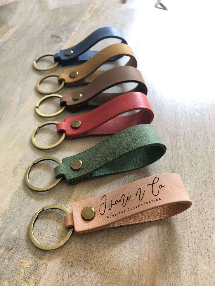 six leather key fobs are lined up on a table with the name don't be