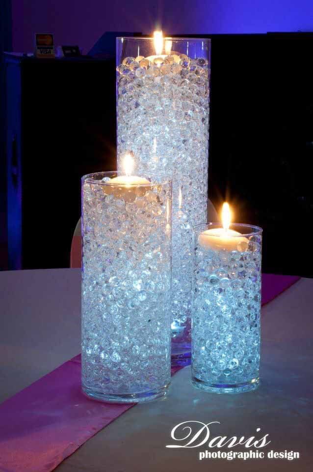 three lit candles are sitting in glass vases