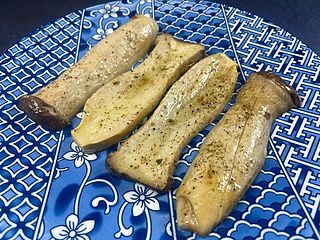 three pieces of fish on a blue and white plate