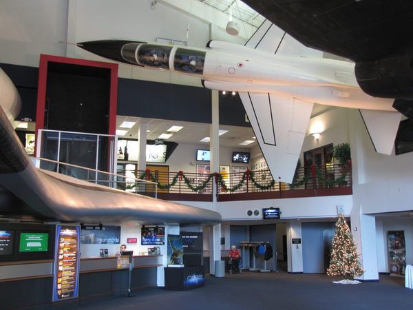 an airplane hanging from the ceiling in a building