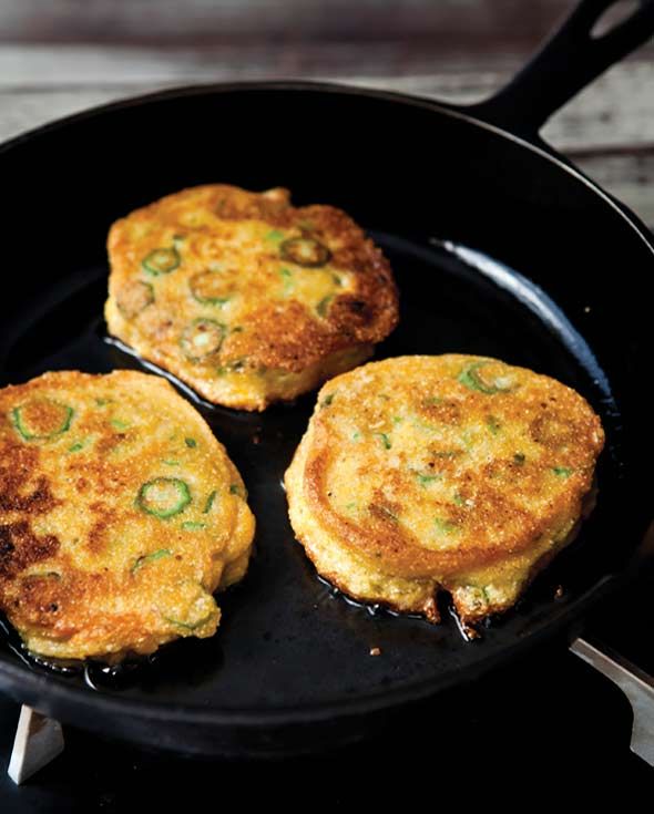 three pancakes cooking in a skillet on top of a stove