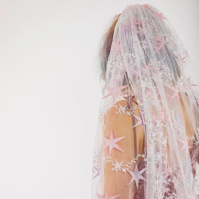 the back of a bride's veil with stars on it