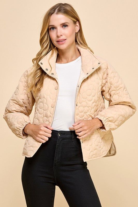 This cute beige jacket boasts a charming floral quilted pattern and playful button down style. Stay cozy and stylish in this unique piece! Fit: True to size. Fabric: 100% polyester Fall Quilted Button-up Jacket With Snap Buttons, Cream Quilted Long Sleeve Outerwear, Cream Quilted Long Sleeve Jacket With Pockets, Cream Long Sleeve Quilted Jacket With Pockets, Quilted Button-up Winter Outerwear, Cozy Spring Button-up Outerwear, Cozy Button-up Spring Outerwear, Cozy Beige Outerwear With Button Closure, Cream Casual Puffer Jacket For Fall