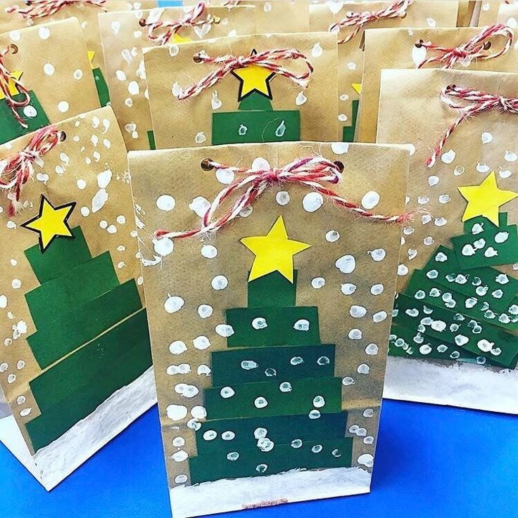 small brown bags decorated with christmas trees and stars