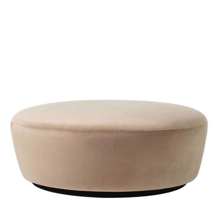 a round ottoman sitting on top of a white floor