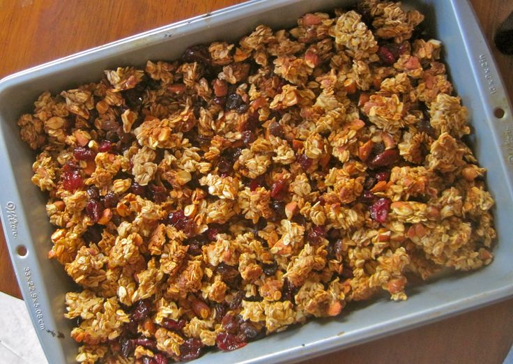 a pan filled with granola sitting on top of a wooden table