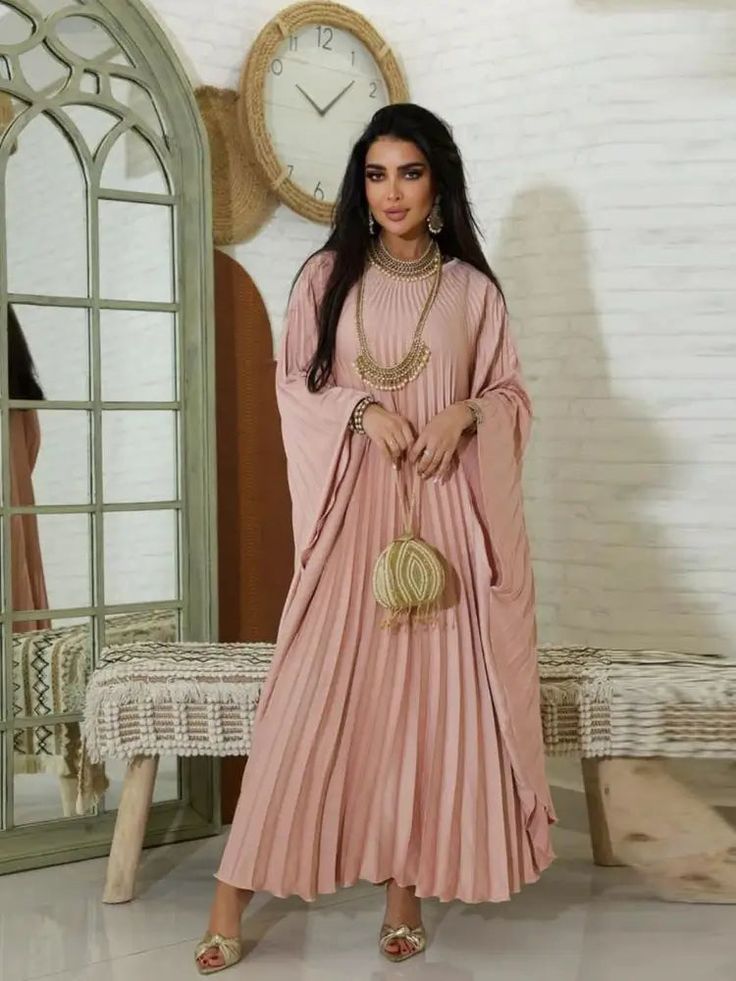 Step into luxurious style and grace with our exquisite Enchanting Sands Maxi Dress - the perfect choice for your upcoming Eid celebration. Inspired by the cultural beauty of Morocco, this pleated, flowing dress captures the essence of traditional elegance with a modern touch. Elevate your style and embrace comfort in this stunning Kaftan Abaya, designed with the contemporary Muslim woman in mind. Features: Pleated design for a graceful, flowing silhouette Rich fabrics and intricate patterns insp Georgette Dress With Cape Sleeves For Eid, Eid Georgette Dress With Cape Sleeves, Traditional Eid Dresses With Cape Sleeves, Festive Georgette Dresses With Cape Sleeves, Wedding Gown With Pleated Maxi Length, Festive Pink Dress With Cape Sleeves, Evening Anarkali Dress With Traditional Drape, Anarkali Evening Dress With Traditional Drape, Anarkali Georgette Dress With Cape Sleeves