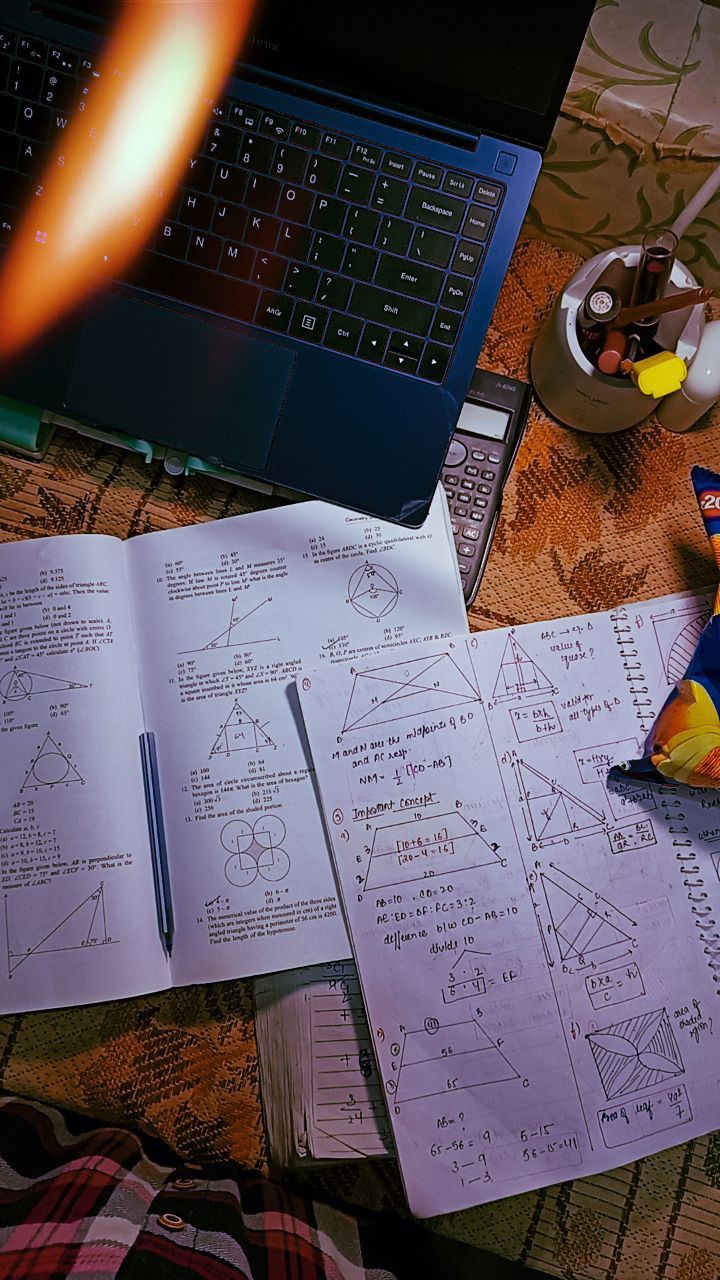 an open notebook sitting on top of a table next to a laptop computer and candy bar