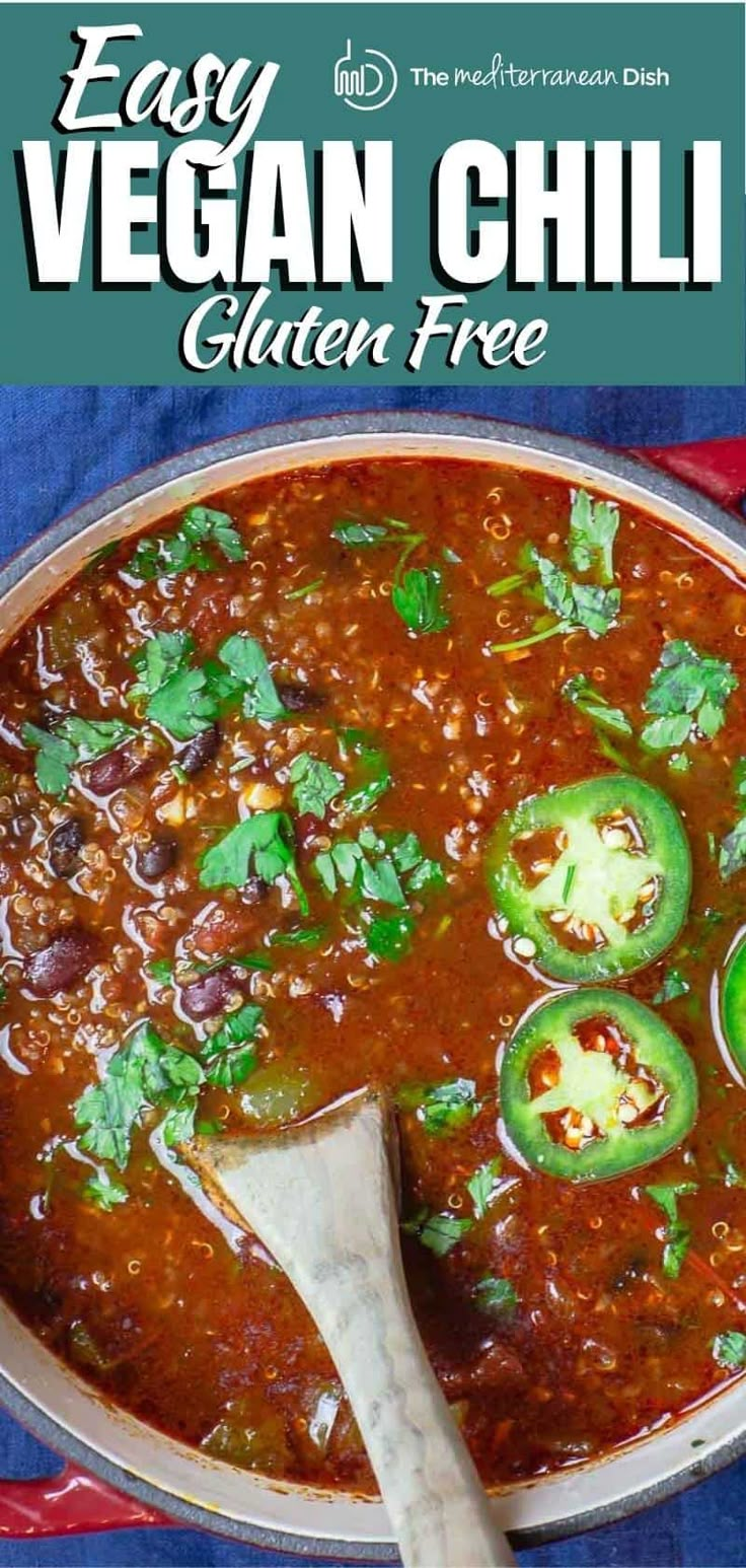 an easy vegan chili recipe in a pan with a wooden spoon on the side