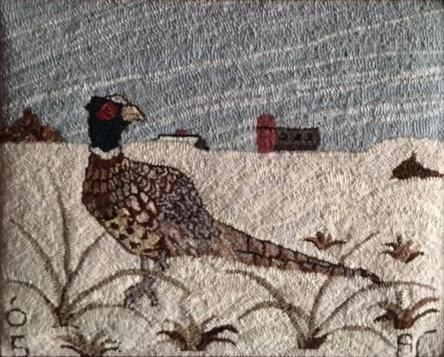 a bird sitting on top of a patch of fabric