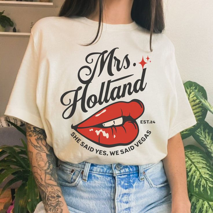 a woman with tattoos wearing a t - shirt that says mrs holland