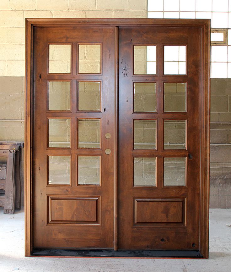 two wooden doors with glass panels on each side