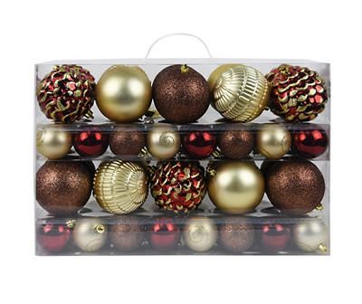 christmas ornaments are arranged in a clear display case with gold and red baubles