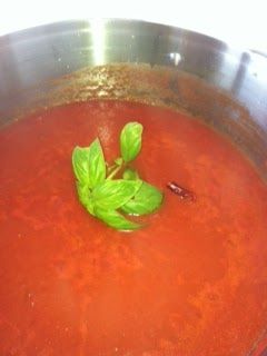 a pot filled with red liquid and green leaves