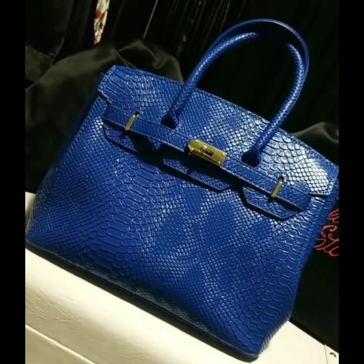 Available In 3 Colors: Black, Blue, And Pink Width: 15" Height (Including Handle): 14" Inner Bag Depth: 8.5" Inner Bag Width (Fully Open) 12" Removable Strap Luxury Blue Bag With Hasp Closure, Classic Blue Bag With Large Capacity, Luxury Blue Bags With Gold-tone Hardware, Classic Large Capacity Blue Bag, Classic Blue Evening Bag, Blue Top Handle Bag With Hasp Closure, Blue Evening Bag With Top Carry Handle, Blue Tote Shoulder Bag For Formal Occasions, Blue Office Bag With Hasp Closure