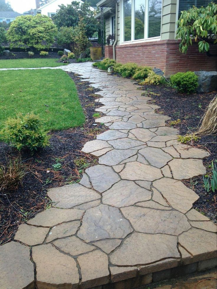 a stone path in front of a house