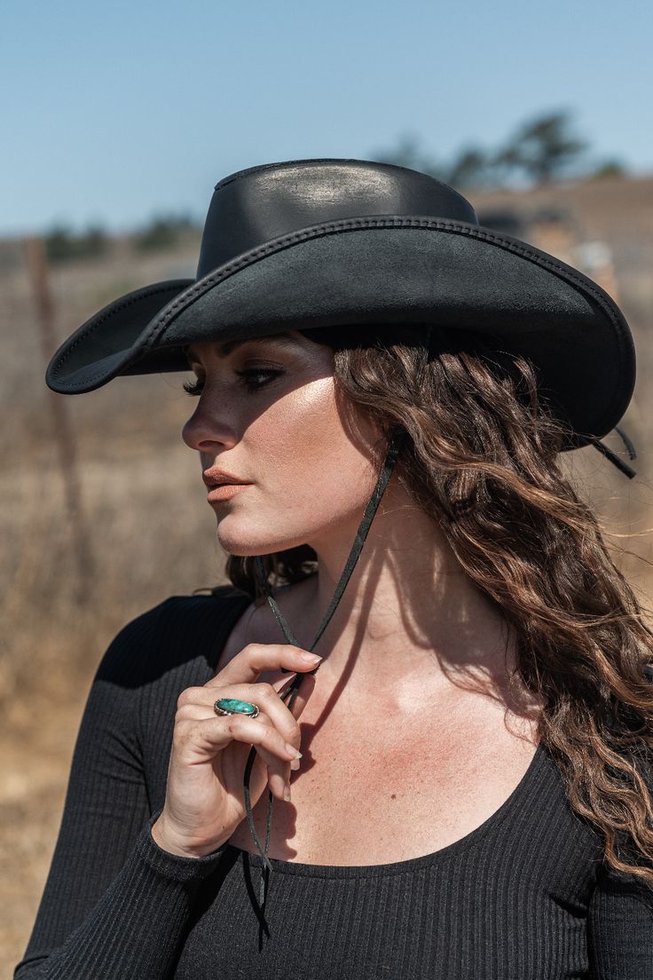 This womens leather cowboy hat is the perfect pairing of form and function. Built using durable, finished, 100% leather, it's built to last and protect you from the sun and rain on any adventure. Yet with its curved brim, and all-leather braided band, it's one of our best-looking hats. Leather Brimmed Hat For Festivals, Leather Brimmed Festival Hats, Country Style Hat Bands For Western-themed Events, Leather Hat Bands For Festivals With Short Brim, Western Style Leather Hat For Festivals, Fitted Leather Hats For Western-themed Events, Black Leather Hat Bands For Rodeo, Fitted Leather Hat For Country Events, Adjustable Leather Hats For Festivals