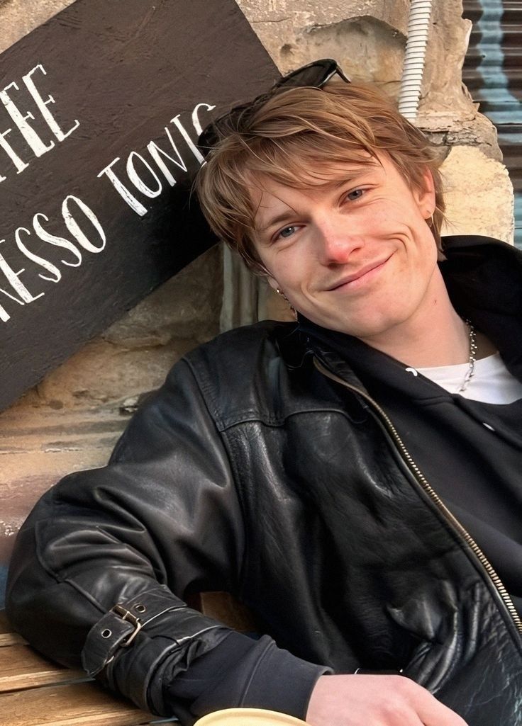 a man sitting at a table with a cup of coffee