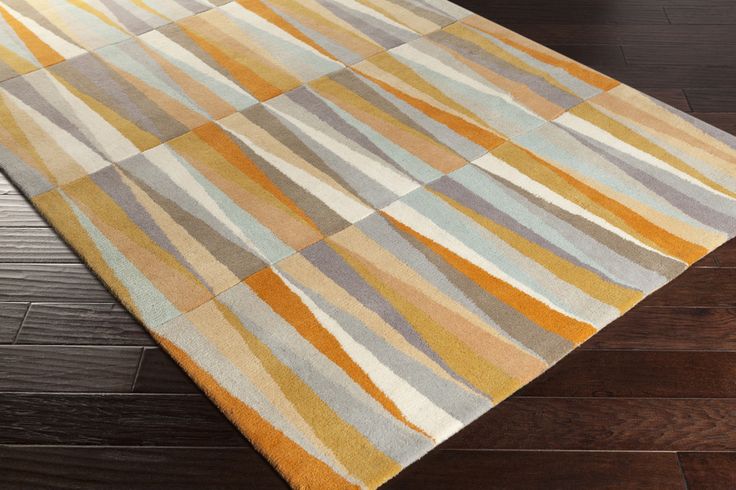 a multicolored area rug with wooden flooring